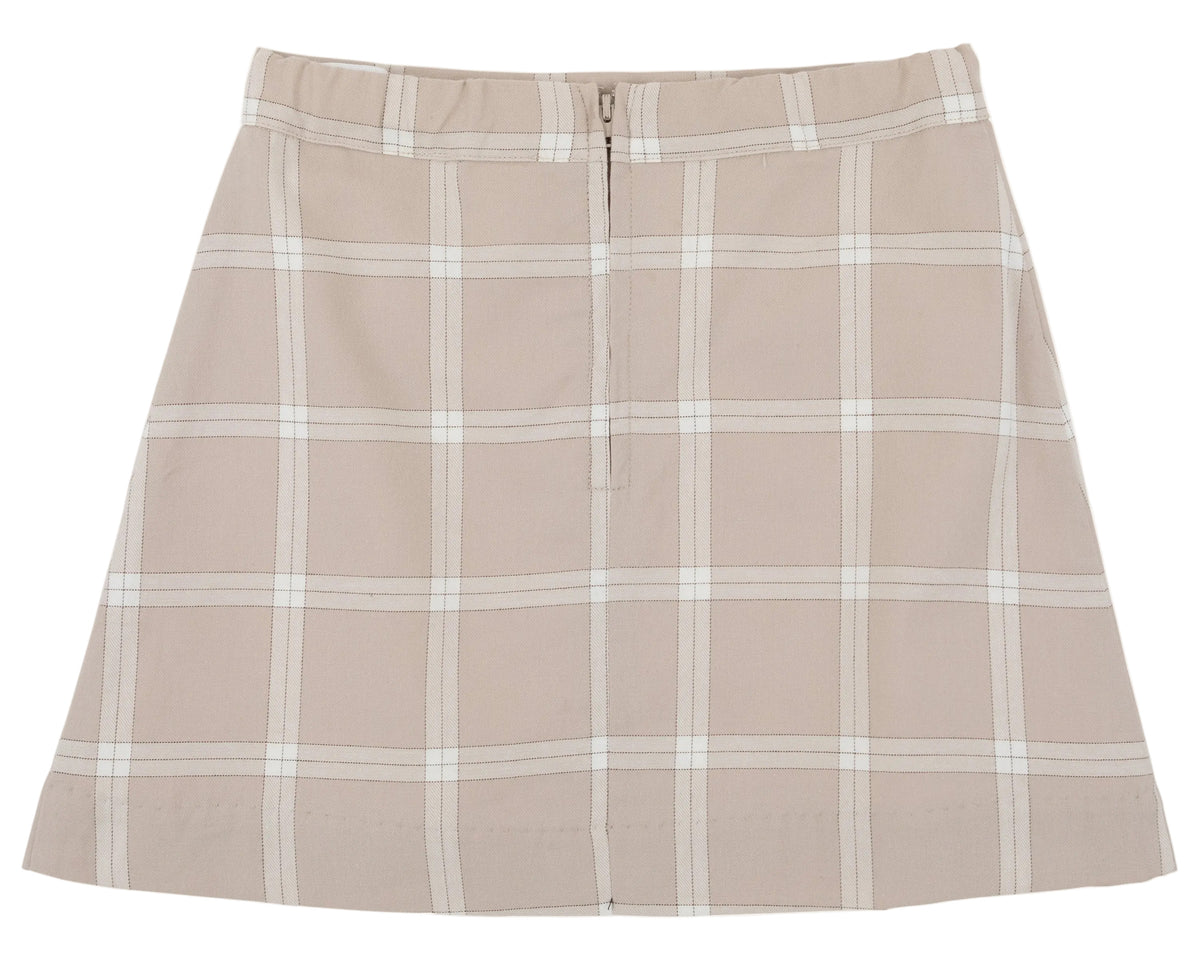 Girls’ Perrin Pocket Flannel Skirt by The Beaufort Bonnet Company in beige plaid with white and light gray stripes, featuring an elastic waistband, back zipper closure, and A-line silhouette, displayed laid flat on a white background.