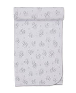 The Sweet Sheep Blanket by Kissy Kissy features a repeating pattern of line-drawn teddy bear faces and small stars on a white background. Neatly rolled at the top, its scalloped edging is visible along the bottom. Crafted from soft Pima cotton, this blanket offers both comfort and charm for your little one.