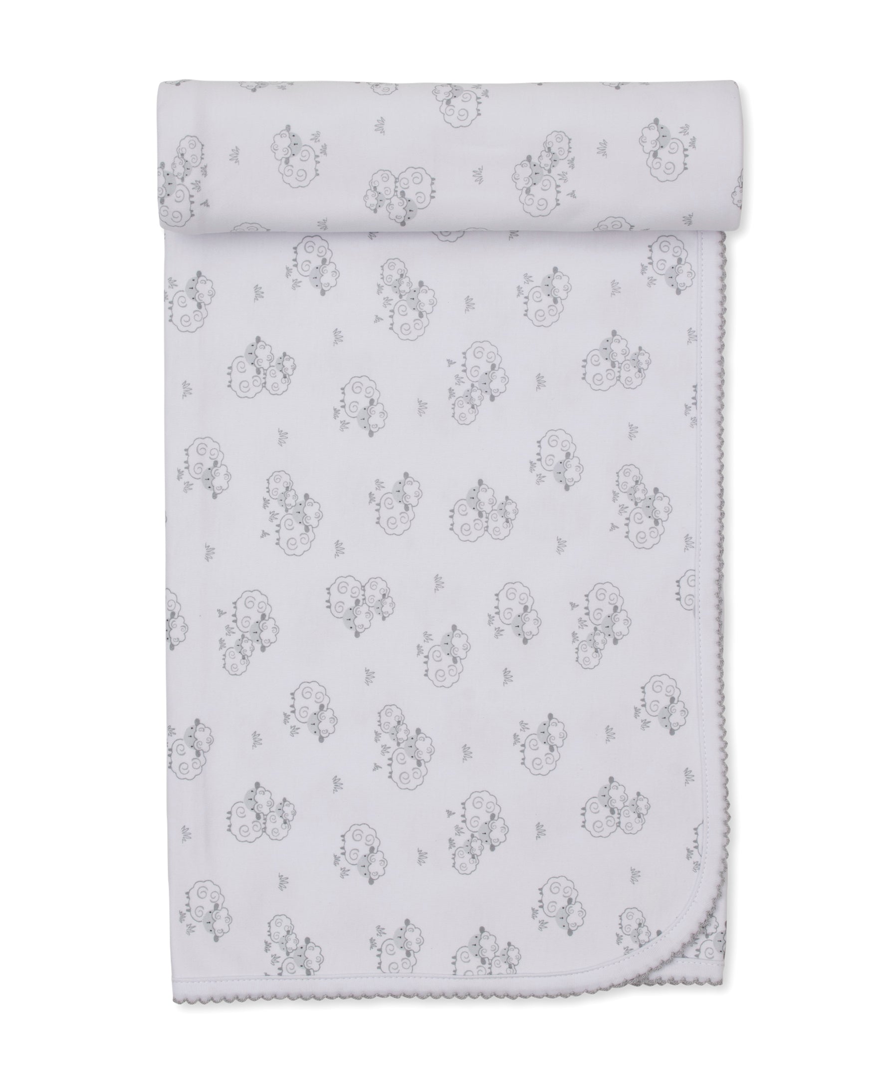 The Sweet Sheep Blanket by Kissy Kissy features a repeating pattern of line-drawn teddy bear faces and small stars on a white background. Neatly rolled at the top, its scalloped edging is visible along the bottom. Crafted from soft Pima cotton, this blanket offers both comfort and charm for your little one.