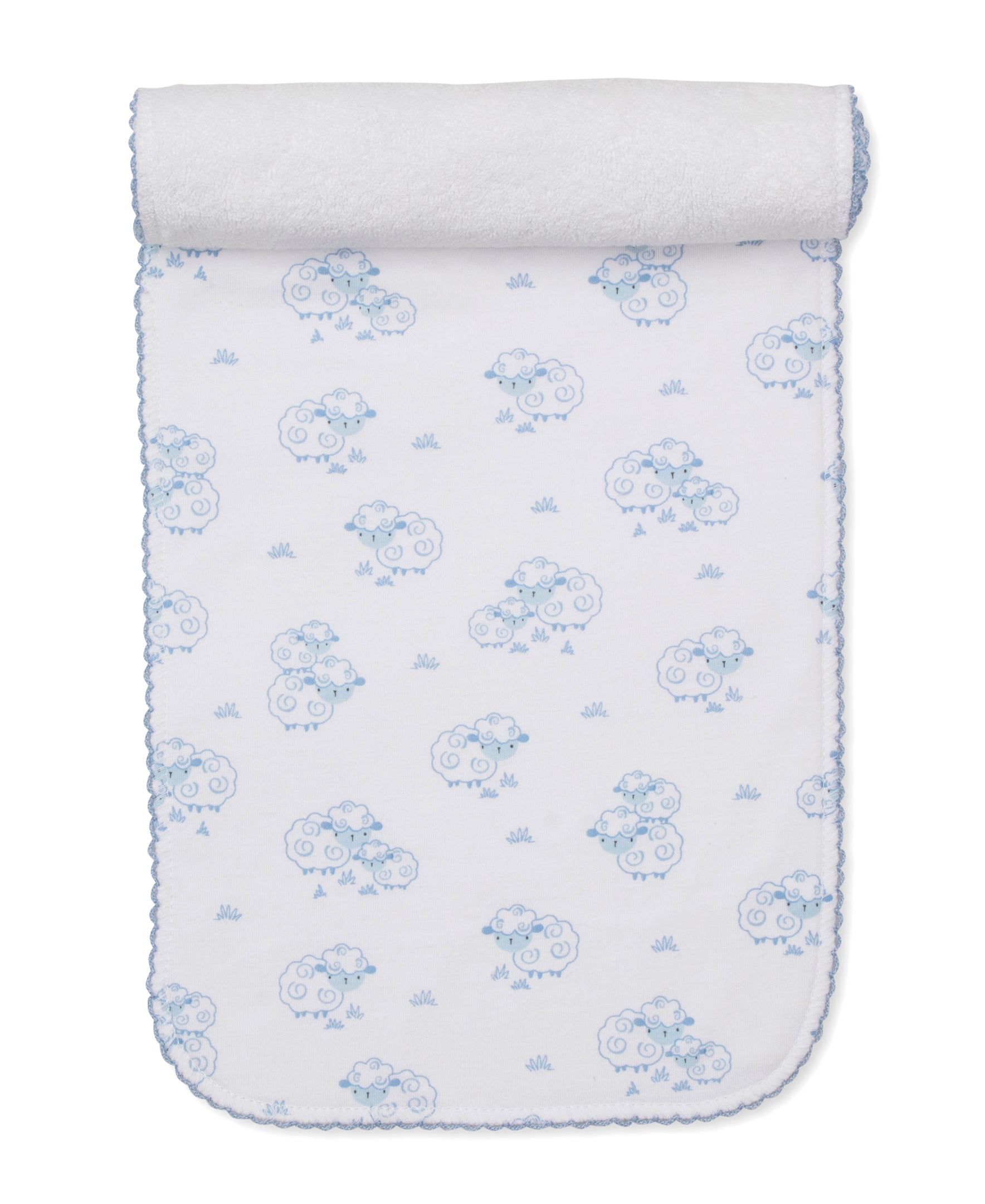 The Kissy Kissy Sweet Sheep Burp Cloth features white Pima cotton adorned with blue sheep and grass patterns, scalloped blue edging, and a rolled end—a soft and cozy essential inspired by classic designs.