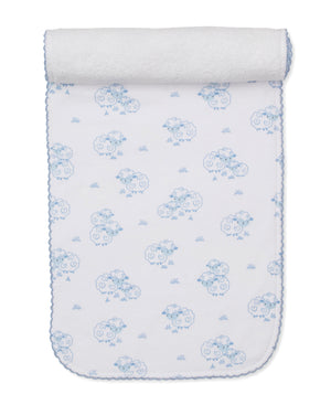 The Kissy Kissy Sweet Sheep Burp Cloth features white Pima cotton adorned with blue sheep and grass patterns, scalloped blue edging, and a rolled end—a soft and cozy essential inspired by classic designs.
