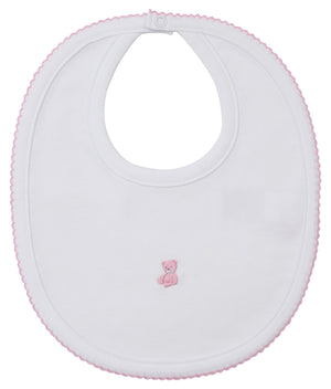 The Kissy Kissy Teddy Bear Time Bib with Hand Emb. is an adorable white Pima cotton bib with pink trim and a hand-embroidered teddy bear—perfect for your little one.