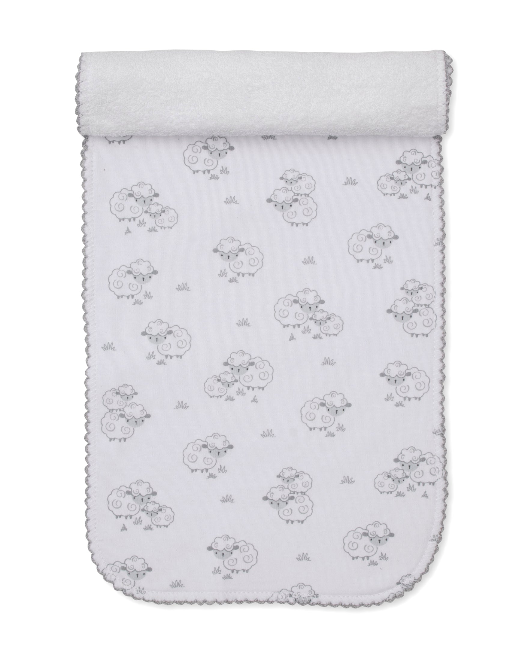 Introducing the Kissy Kissy Sweet Sheep Burp Cloth: crafted from white Pima cotton and featuring adorable gray cartoon sheep and grass details, rounded edges, and a delicate scalloped trim. Soft and versatile, it comes partially rolled at the top—perfect as a cozy layer or as a gentle burp cloth for your baby.