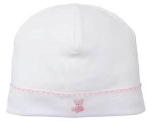 The Kissy Kissy Teddy Bear Time Hat with Hand Emb features soft white Pima cotton, pink scalloped trim, and a hand-embroidered teddy bear from the Teddy Bear Collection.