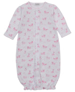 Kissy Kissy Baby Puppy Paws Printed Convertible Gown features long sleeves, a pink puppy paws print, front snap closures, and an elasticized hem at the bottom.