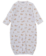 The Kissy Kissy Baby Puppy Paws Printed Convertible Gown is a white Pima cotton baby sleep sack with long sleeves and front snap buttons. Featuring an all-over brown animal print of playful puppies and squirrels, this ultra-soft gown ensures comfort for your little one, while the adorable puppy paws design adds a charming touch.