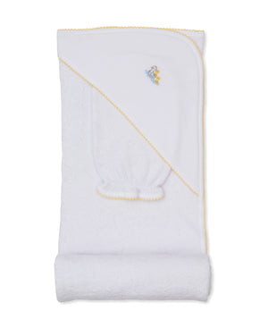 The Duck Pond Paddles Hooded Towel with Mitt by Kissy Kissy features a white design with yellow trim and an embroidered duck, neatly folded to showcase the hooded corner. Crafted from soft Pima cotton, this gentle and absorbent bathtime towel is perfect for your little one.