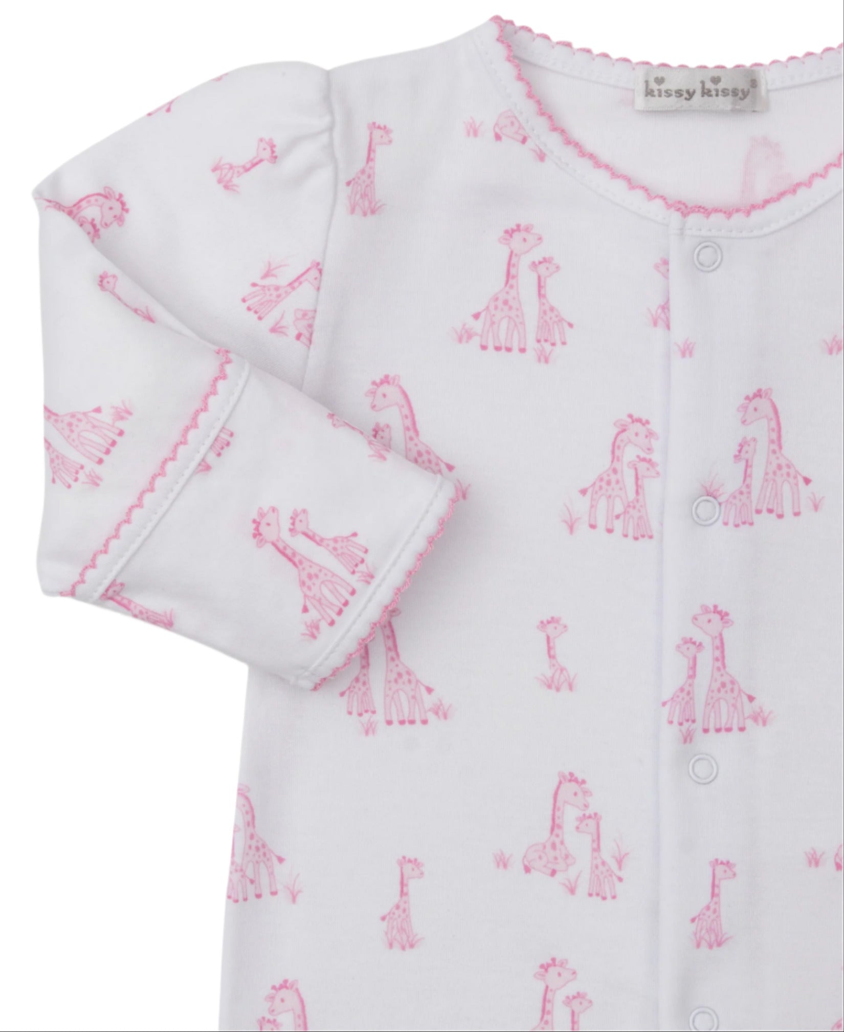 The Kissy Kissy Baby Girls' Giraffe Grace Printed Footie features soft Pima cotton, a pink giraffe print, pink scalloped cuffs and collar, front snaps, and a visible brand label on the neckline.