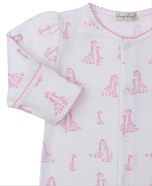 The Kissy Kissy Baby Girls' Giraffe Grace Printed Footie features soft Pima cotton, a pink giraffe print, pink scalloped cuffs and collar, front snaps, and a visible brand label on the neckline.