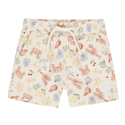 Beige Rylee + Cru Board Short by Rylee & Cru features a drawstring waist and a vibrant sea-themed pattern with crabs, fish, shells, and starfish. Ideal for pairing with a matching swim top.