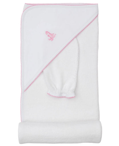 The Kissy Kissy Giraffe Grace Hooded Towel & Mitt Set in white features pink trim and an embroidered pink giraffe, shown folded with the hood and matching mitt—ideal for baby bathtime.
