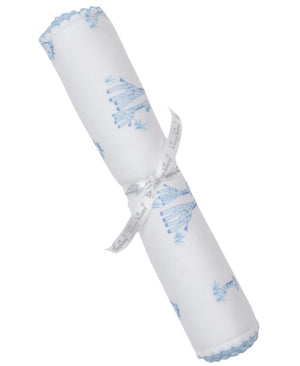 The Kissy Kissy Giraffe Grace Burp Cloth features white Pima cotton with blue giraffe prints and scalloped edges, rolled and tied with a white ribbon.