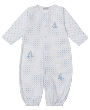 The Kissy Kissy Baby' Giraffe Grace Dotted Convertible Gown is a white, long-sleeve playsuit with blue polka dots and small blue giraffe illustrations on the chest, hip, and legs.