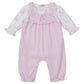 The Kissy Kissy Baby's Giraffe Grace Overall Set features pink overalls with ruffled straps and a giraffe print long-sleeve shirt, plus snap buttons at the legs and a chest ruffle detail.