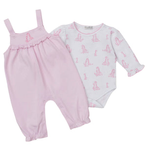 The Kissy Kissy Baby' Giraffe Grace Overall Set features pink baby overalls with ruffled straps and a long-sleeve pima cotton bodysuit adorned with a cute pink giraffe print.