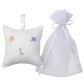 The Kissy Kissy Safari Wild Musical Pillow, featuring embroidered safari animals, sits next to a sheer tulle bag—an adorable baby gift.