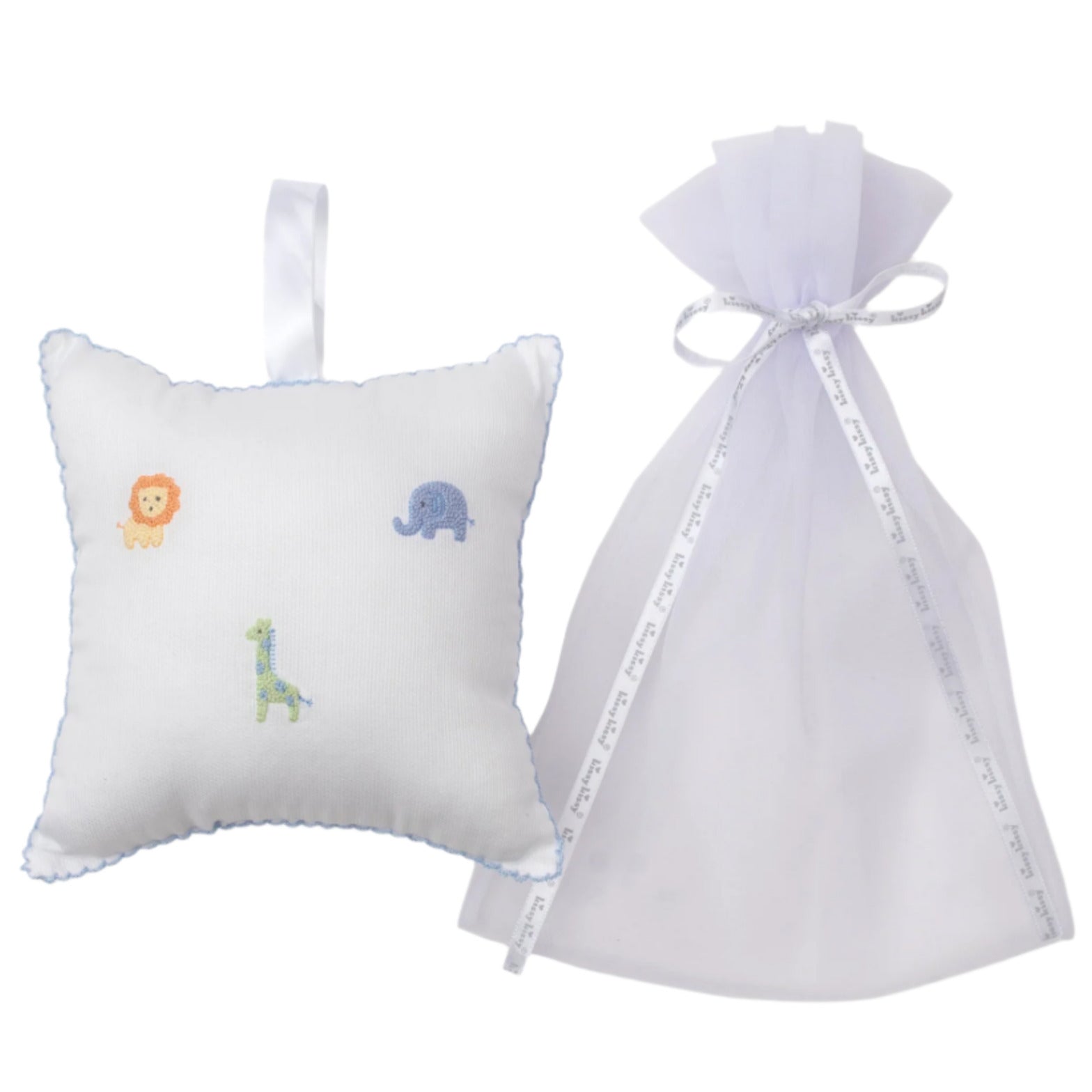 The Kissy Kissy Safari Wild Musical Pillow, featuring embroidered safari animals, sits next to a sheer tulle bag—an adorable baby gift.
