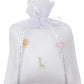 The Kissy Kissy Safari Wild Musical Pillow comes in a white tulle gift bag adorned with embroidered safari animals—lion, giraffe, and elephant—making it a charming present for baby essentials.