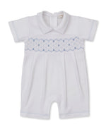 The Kissy Kissy Baby Boys’ Short Playsuit features short sleeves, a collar, and delicate blue smocking detail across the chest. Crafted from soft Pima cotton for superior comfort, this hand-smocked romper is displayed against a plain white background.