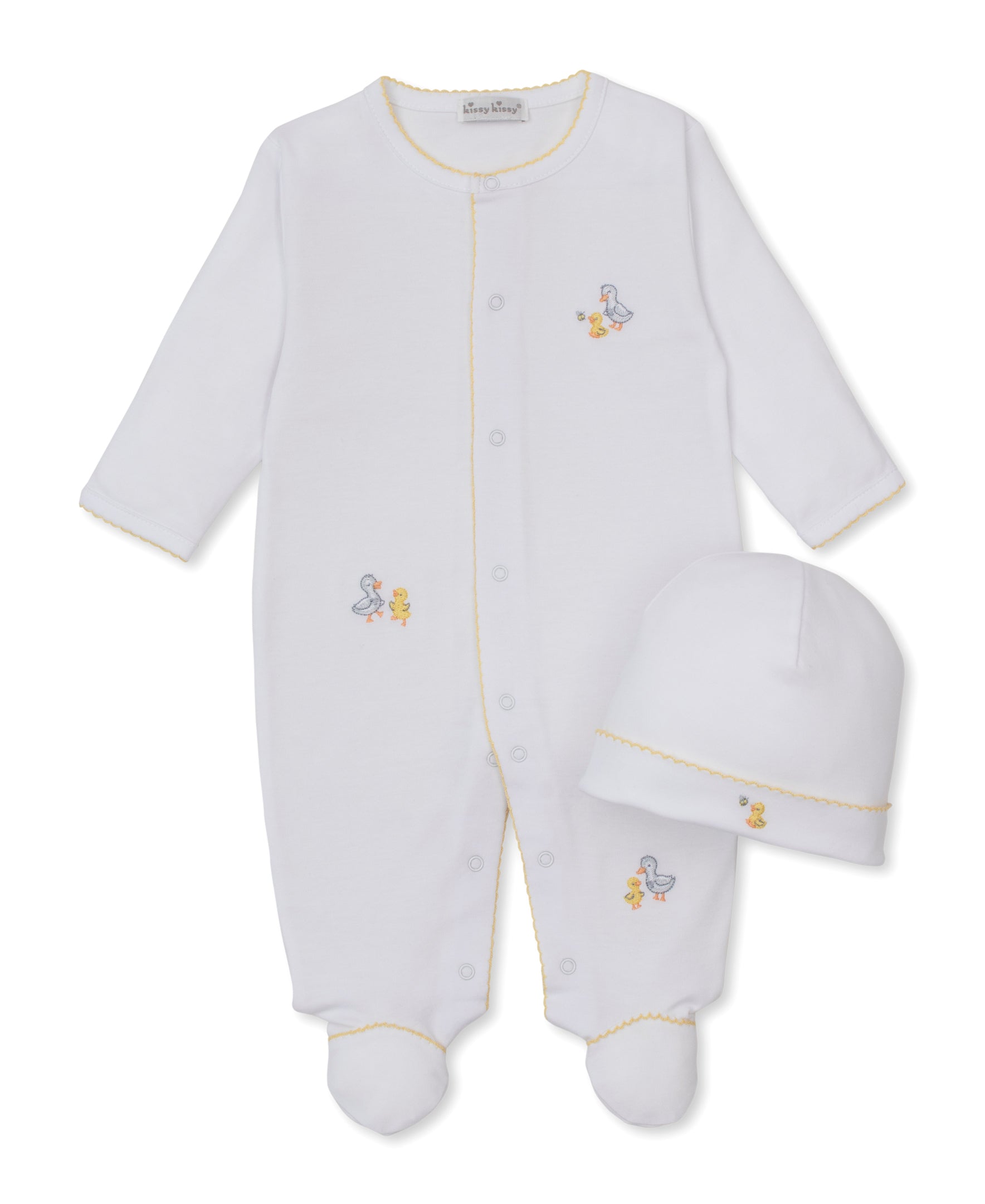The Kissy Kissy Baby Duck Pond Paddles Footie with Hat Set features a white footed onesie accented with yellow trim and charming duck embroidery, paired with a matching white hat. Expertly crafted from soft Pima cotton, this adorable two-piece set is perfect for keeping your little one cozy and comfortable.