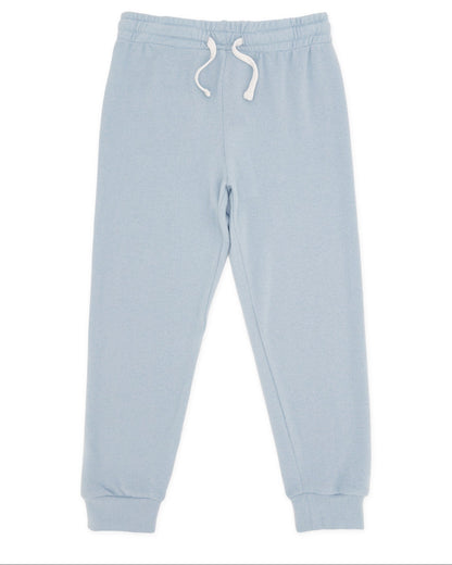 The Feather 4 Arrow Baby and Kids’ Hudson Hacci Jogger features a light blue relaxed fit with an elastic waistband, white drawstring, and cuffed ankles, shown laid flat on a white background.