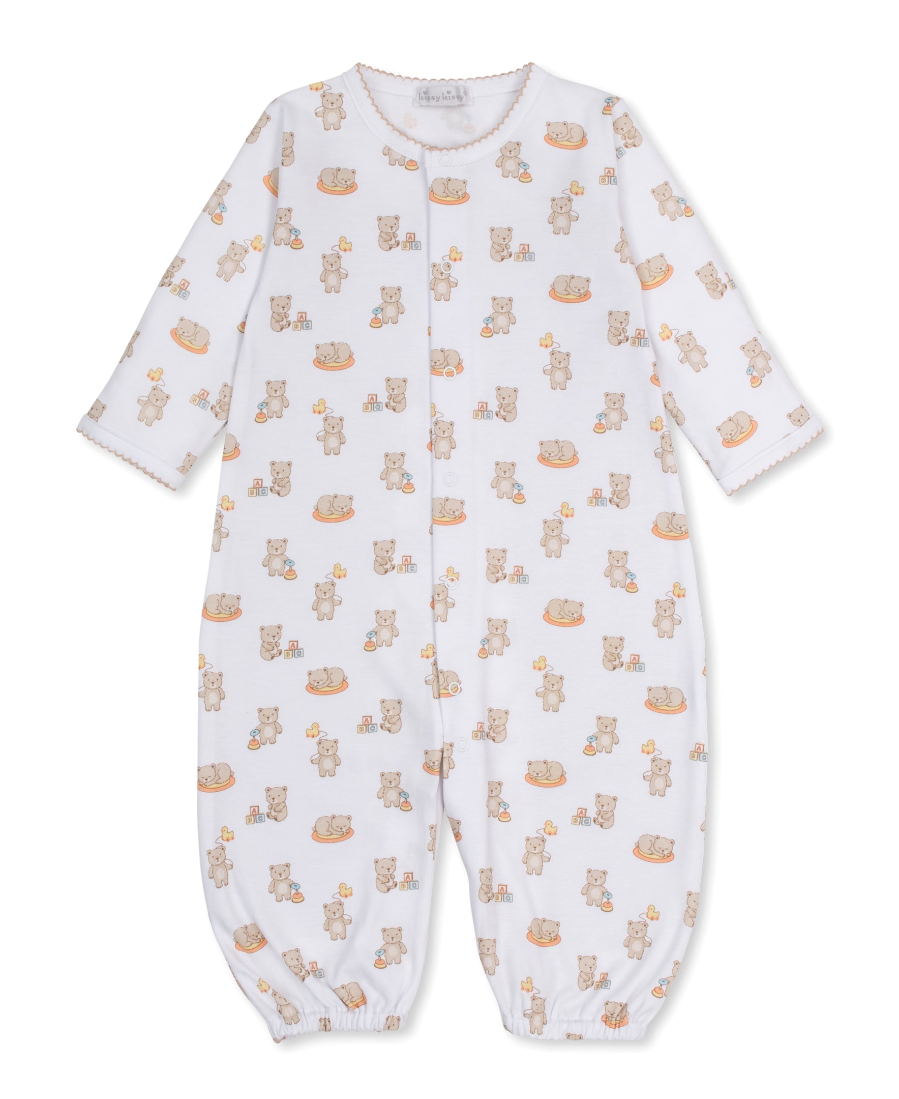 The Kissy Kissy Baby Beary Blessed Convertible Gown is a white infant romper crafted from soft Pima cotton, featuring long sleeves and an adorable teddy bear and toy block print. Designed with snap buttons down the front and elastic cuffs at the wrists and ankles, this versatile playsuit easily converts into a cozy baby gown for added convenience.