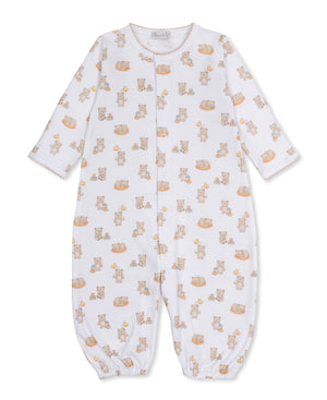The Kissy Kissy Baby Beary Blessed Convertible Gown is a white infant romper crafted from soft Pima cotton, featuring long sleeves and an adorable teddy bear and toy block print. Designed with snap buttons down the front and elastic cuffs at the wrists and ankles, this versatile playsuit easily converts into a cozy baby gown for added convenience.