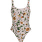 The Gema One Piece by Agua By Agua Bendita is a recycled polyester swimsuit with a white base, green, yellow, and orange floral-vine print, and UPF 50 sun protection—perfect for stylish safety under the sun.