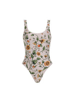 The Gema One Piece by Agua By Aguabendita is a scoop-neck swimsuit made from recycled polyester, featuring a colorful floral print on a light background with UPF 50 protection, shown against a white backdrop.
