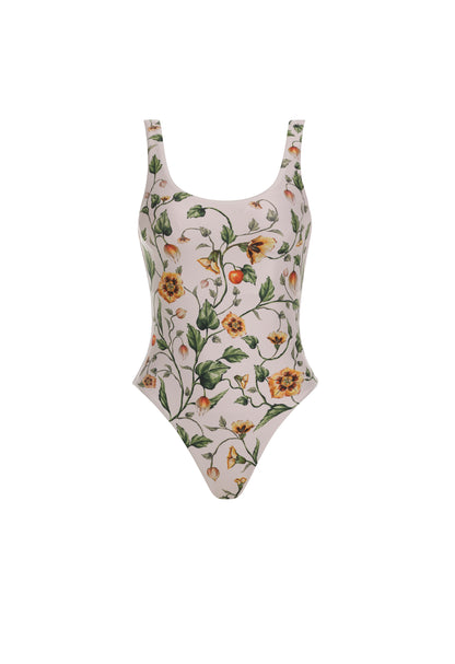 The Gema One Piece by Agua By Aguabendita is a scoop-neck swimsuit made from recycled polyester, featuring a colorful floral print on a light background with UPF 50 protection, shown against a white backdrop.