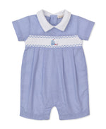 The Kissy Kissy Baby Boys' CLB Summer Medley Short Playsuit features a light blue gingham design with short sleeves, a white Peter Pan collar, and a white smocked panel across the chest adorned with charming sailboat embroidery. Crafted from soft Pima cotton for ultimate comfort.