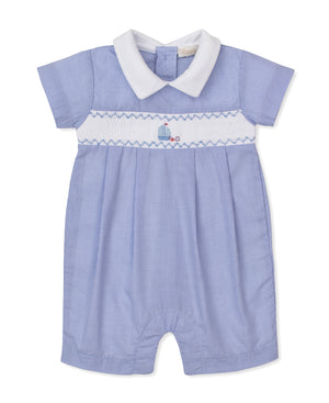 The Kissy Kissy Baby Boys' CLB Summer Medley Short Playsuit features a light blue gingham design with short sleeves, a white Peter Pan collar, and a white smocked panel across the chest adorned with charming sailboat embroidery. Crafted from soft Pima cotton for ultimate comfort.