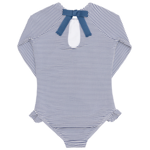 The Minnow Girls' Pacific Stripe Rashguard One Piece features long sleeves, navy and white stripes, a back keyhole opening, a navy neck bow, and cute ruffle hip accents.
