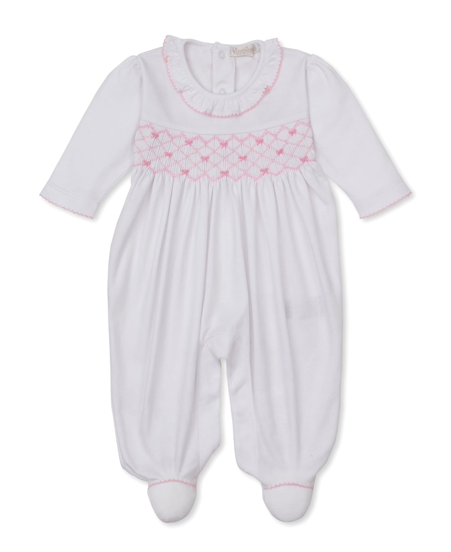 The Kissy Kissy Baby Girls’ Bows Footie is a white, long-sleeve Pima cotton footie featuring delicate pink smocking and trim, back buttons, and a ruffled collar for a cozy touch.