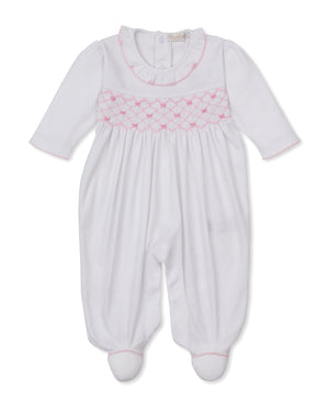 The Kissy Kissy Baby Girls’ Bows Footie is a white, long-sleeve Pima cotton footie featuring delicate pink smocking and trim, back buttons, and a ruffled collar for a cozy touch.