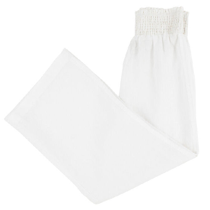 Girls’ Lenai Lounge Pant by The Beaufort Bonnet Company in Worth Avenue White, featuring a wide-leg linen silhouette and a smocked elastic waistband, neatly folded on a plain white background.