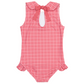 The Minnow Girls' Malibu Poppy Gingham Rounded Collar One Piece is a sleeveless red and white romper featuring ruffle leg openings, a rounded collar, and a pink bow at the back of the neck.