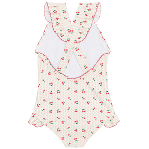 The Minnow Girls' Summer Cherries Ruffle Edge One Piece is a cute swimsuit with ruffled cross-back straps, pink trim, and cherry print, shown flat on a white background.