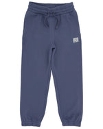 The Feather 4 Arrow Boys’ Wyatt Jogger features a dark blue color, an elastic adjustable waistband with a drawstring, and elastic cuffs. Designed for everyday comfort, these sweatpants include a small rectangular patch sewn near the left pocket.