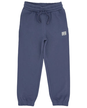 The Feather 4 Arrow Boys’ Wyatt Jogger features a dark blue color, an elastic adjustable waistband with a drawstring, and elastic cuffs. Designed for everyday comfort, these sweatpants include a small rectangular patch sewn near the left pocket.