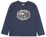The Feather 4 Arrow Boys’ Surf Club Long Sleeved Tee features a navy design with a surfing-inspired “Stay Stoked Surf Club” graphic, showing a wave and an orange sun on the front—perfect for kids’ everyday wear.