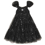 The Noralee Girls’ Clara Dress Silver Stars features a smocked bodice, puffed sleeves, and a tulle skirt embellished with silver star patterns, accented by a large silver star at the chest.