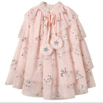 Introducing the Noralee Tulle Cape – a light pink girls’ dress featuring layered tulle cape sleeves, floral sequin embroidery, and two star-embroidered tassels at the collar. A charming choice for any special occasion or dress-up moment.
