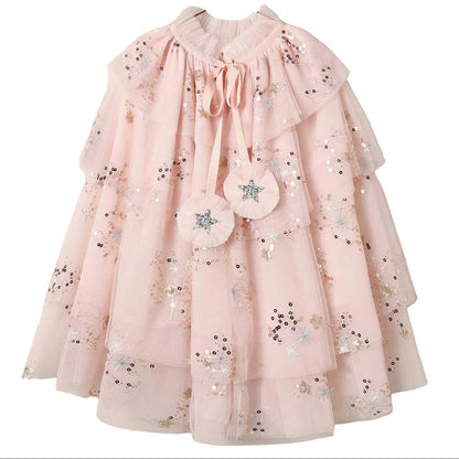 Introducing the Noralee Tulle Cape – a light pink girls’ dress featuring layered tulle cape sleeves, floral sequin embroidery, and two star-embroidered tassels at the collar. A charming choice for any special occasion or dress-up moment.