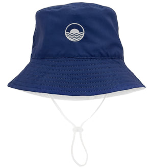 The Feather 4 Arrow Suns Out Reversible Bucket Hat, designed by Feather 4 Arrow, is adorned with a white wave logo and includes an adjustable chin strap, making it ideal for sunny days.