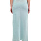A person is shown from the back against a white background, wearing the Simkhai Vienna Midi Skirt in light blue paired with beige heeled sandals.
