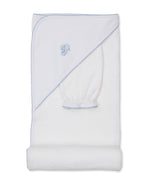 The Kissy Kissy Sweet Sheep Hooded Towel with Mitt is crafted from luxurious Pima cotton and features a white hood adorned with a delicate blue embroidered sheep design and matching trim. The towel is displayed with the hood and coordinating wash mitt visible.