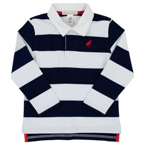 The Boys’ Rollins Rugby Shirt by The Beaufort Bonnet Company features navy and white horizontal stripes, a crisp white collar, and a small pink flamingo logo on the left chest. Made from soft Pima cotton, it offers ultimate comfort and style.