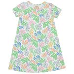 The Beaufort Bonnet Company’s Baby Girls’ and Girls’ Polly Play Dress is a short-sleeve, A-line style made from soft Pima cotton knit, featuring a multicolored floral pattern with green leaves and pink, orange, yellow, and purple flowers on a white background.