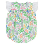 The Beaufort Bonnet Company’s Baby Girls’ Angel Sleeve Blythe Bubble features a colorful floral print, white eyelet lace flutter sleeves inspired by its signature angel sleeve design, and a gathered neckline crafted from soft Pima Cotton, showcased against a white background.